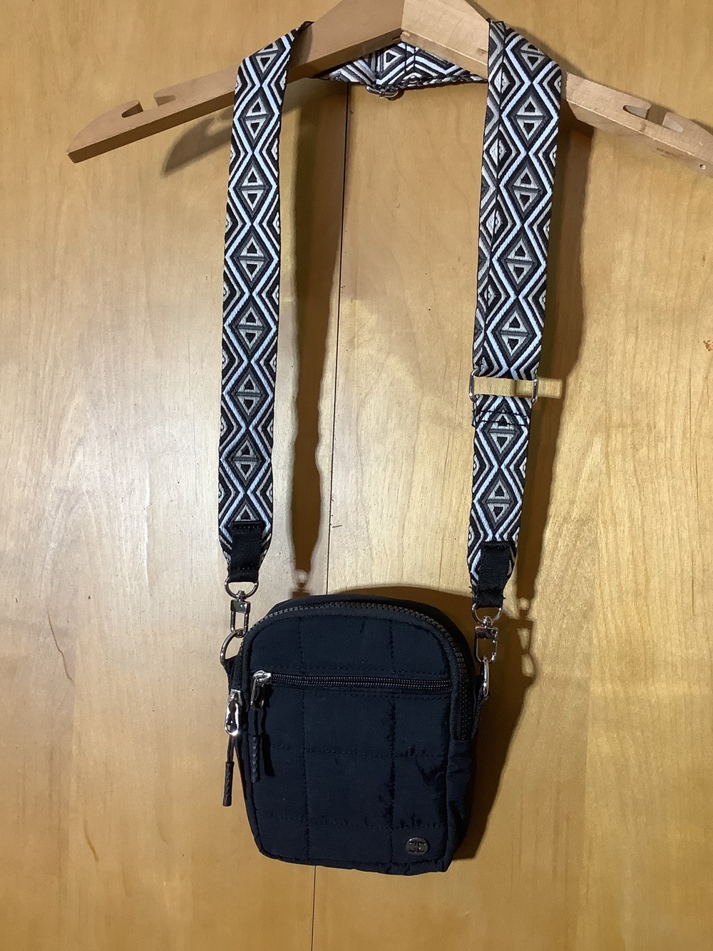 Black quilted crossbody with guitar style strap